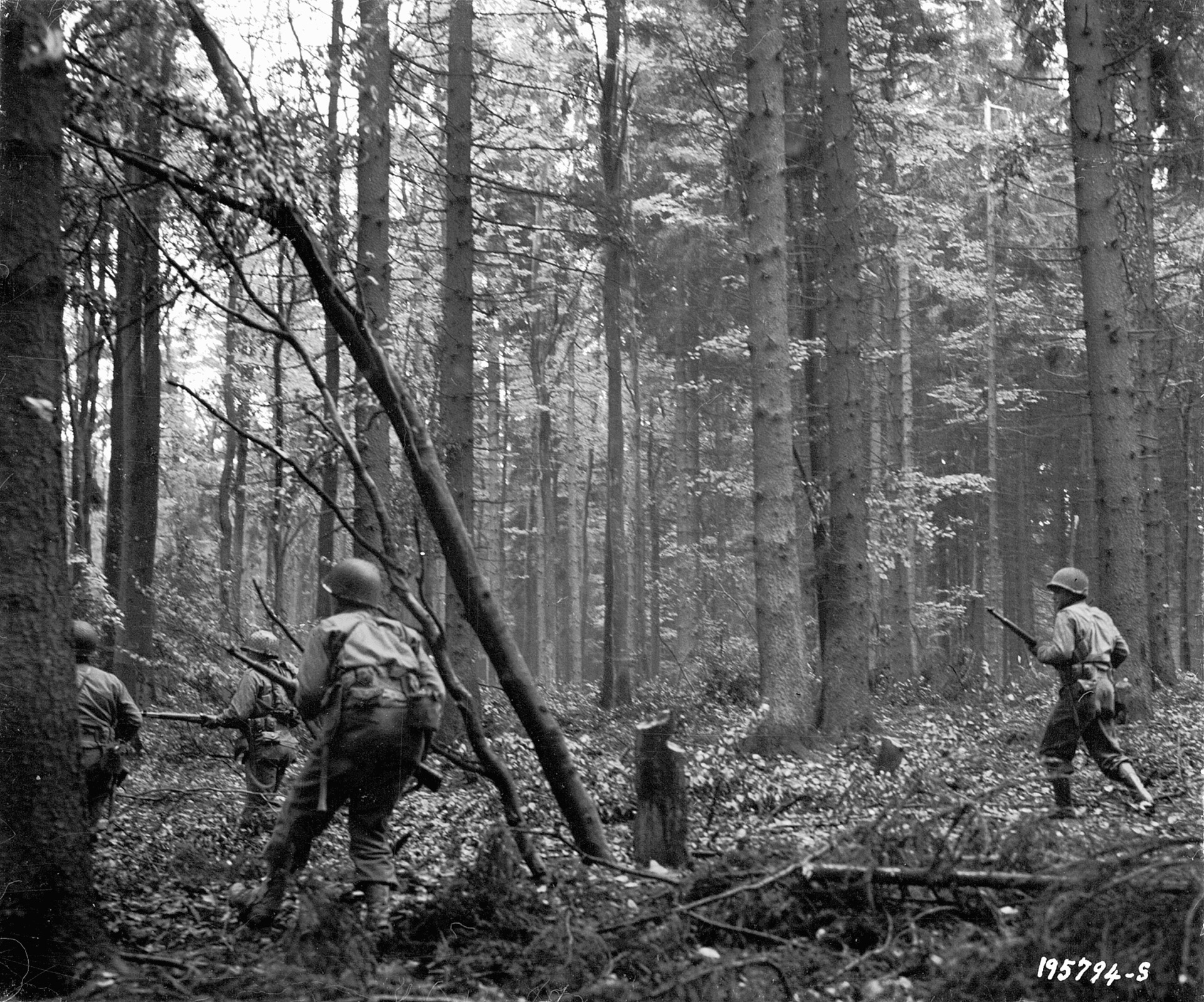 The heavily wooded terrain restricted visibility and mobility. Here a squad of 28th Infantry Division men advances cautiously through the Hürtgen Forest near Vossenack during the attack on Schmidt, November 3.